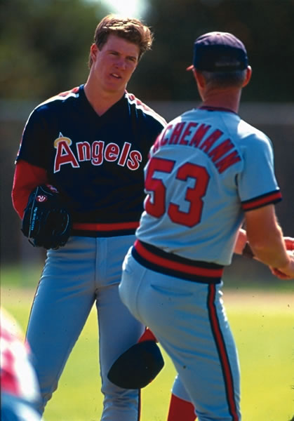 Jim Abbott of the California Angels meets on the mound with his