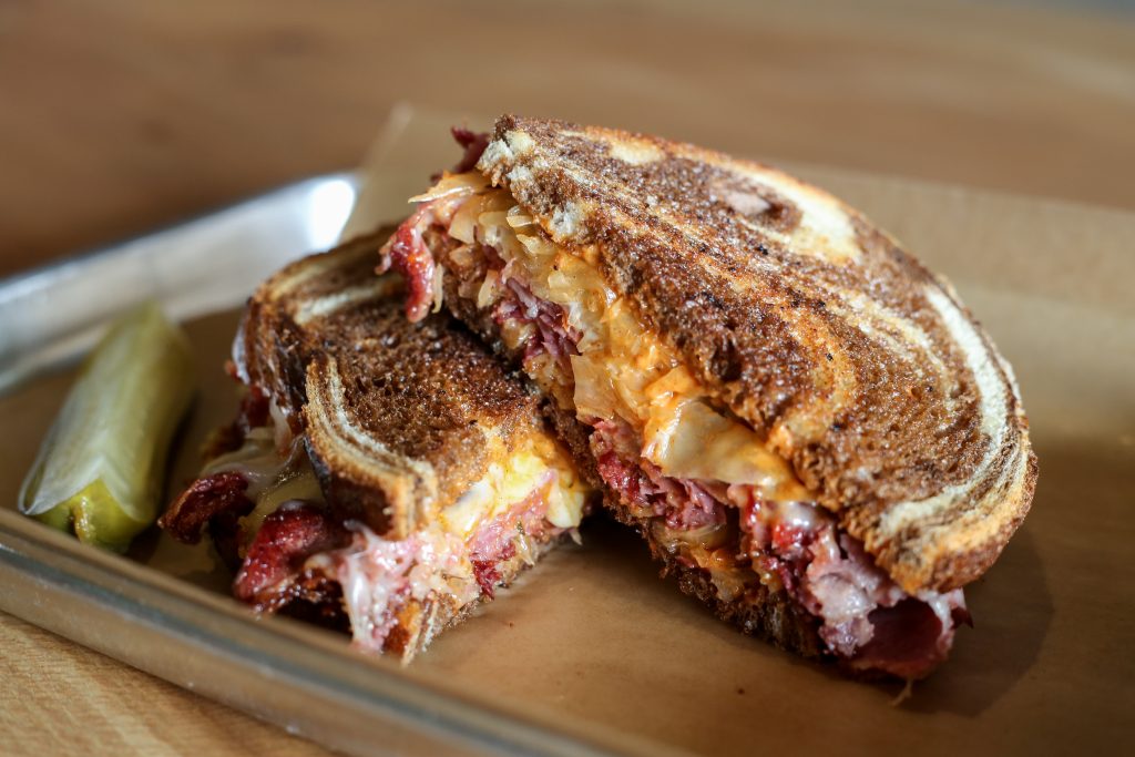 Rubinstein sandwich: classic corned beef with thick slices of meat, sauerkraut, Swiss cheese and Russian dressing.