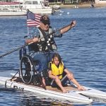 Vet with boy on SUP Veterans Relief Foundation